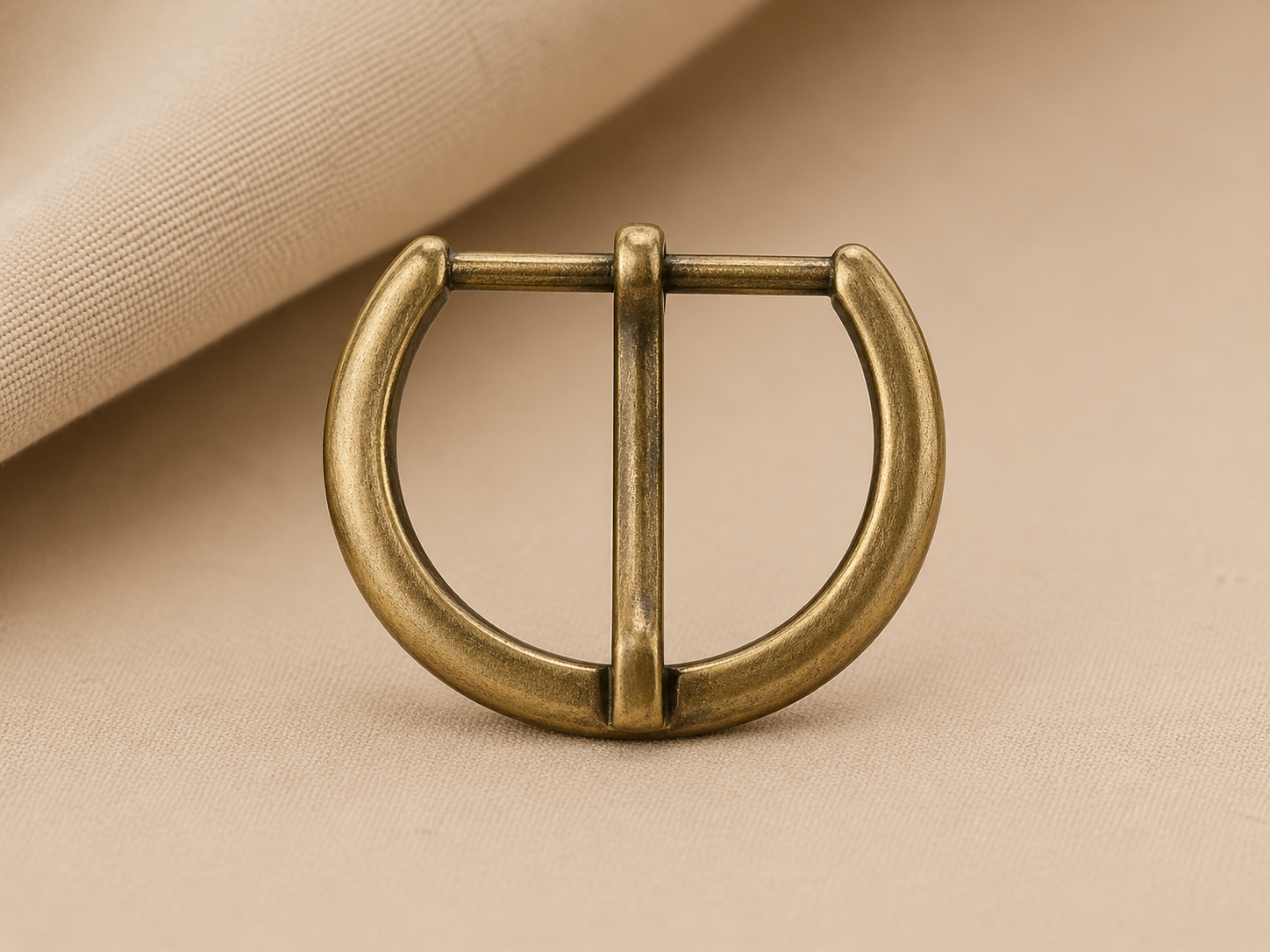 Antique brass half-round buckle on fabric
